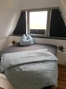 Ένα ή περισσότερα κρεβάτια σε δωμάτιο στο Bigge Huus Ferienhaus