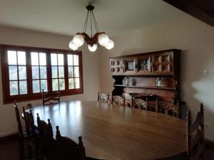 a dining room with a large wooden table and chairs at La Casa de les Oques in Espinelvas