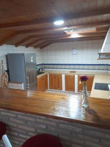 a kitchen with a wooden counter and a refrigerator at El bujio in San Fernando