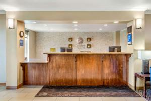 a hotel lobby with a large wooden reception desk at Comfort Inn & Suites Lancaster Antelope Valley in Lancaster