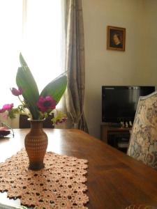 a vase of flowers sitting on a wooden table at Beautiful HOUSE in Trouville / Swimming Pool 12 persons in Trouville-sur-Mer