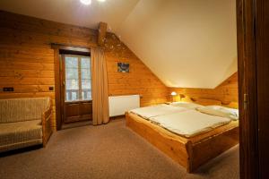 Un dormitorio con una cama grande y una ventana en Srub Karolina en Deštné v Orlických horách