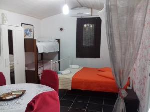 a bedroom with a bed with an orange blanket at B&B Arcafelice in Termoli