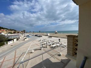 a view of the beach from the balcony of a building at HOTEL RESTAURANT LA COTE REVEE in Leucate