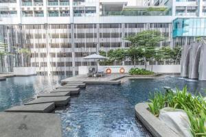 a swimming pool in the middle of a building at Maxhome at Fraser Residence KL in Kuala Lumpur