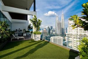 a balcony with a view of the city at Maxhome at Fraser Residence KL in Kuala Lumpur