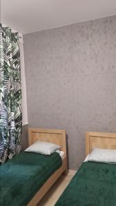 Łóżko lub łóżka w pokoju w obiekcie Apartamenty Bulwar Nadmorski, Ustka