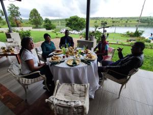 a group of people sitting around a table at Goggas Nest BNB & Restaurant in Matsapha
