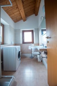 a bathroom with a washing machine and a sink at Agriturismo Conero in Ancona +76 photos