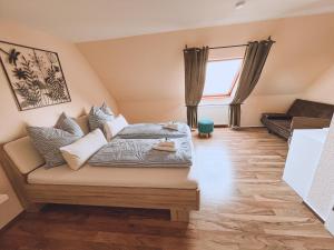 a living room with a bed and a couch at Landhotel "Schwarzach am Main" in Schwarzach am Main