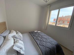 a bedroom with a bed and a window at Casa Queralt in Les Cases d'Alcanar