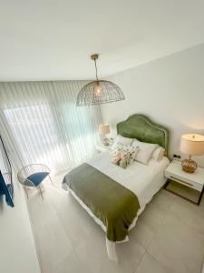 a bedroom with a large bed with a green headboard at Sunset Waves 3 Benidorm in Benidorm +34 photos