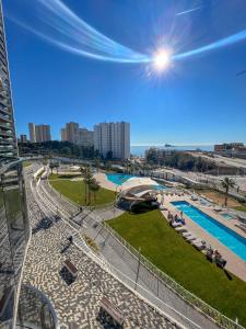 a view of a park with a swimming pool at Sunset Waves 3 Benidorm in Benidorm