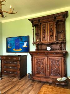 a large wooden entertainment center in a living room at Villa Hainberg in Rauschenbach