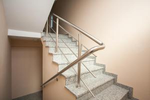 a staircase with a metal handrail in a building at Apartments TM in Krk