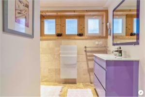 a kitchen with purple cabinets and a purple refrigerator at CHAMBRE INDÉPENDANTE avec SALLE DE BAIN INDÉPENDANTE au RDC d un chalet à 25 kms Chamonix in Saint-Gervais-les-Bains