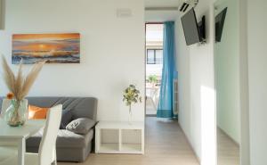 a living room with a couch and a table at I SUONI DEL MARE in Porto San Giorgio
