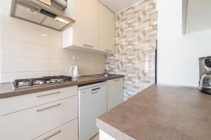 a kitchen with white cabinets and a counter top at Apartment Lidija in Dubrovnik
