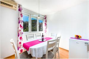 a dining room with a table and chairs and a window at Apartment Lidija in Dubrovnik
