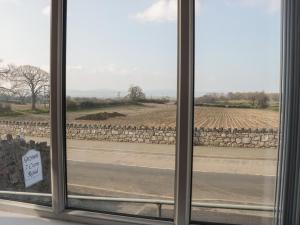 a view of a field from a window at Gwynant in Rhyl