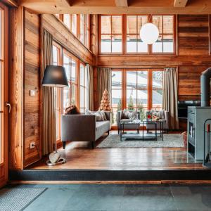 a living room with a couch and a table at IM WEIDACH Superior Chalets in Leutasch