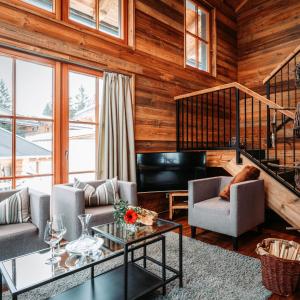 a living room with a couch and a table at IM WEIDACH Superior Chalets in Leutasch