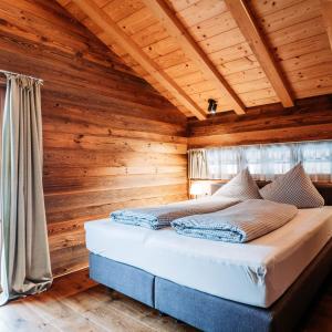 A bed or beds in a room at IM WEIDACH Superior Chalets