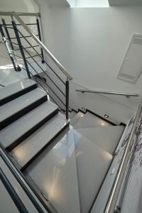 a metal staircase in a building with a glass floor at Marien Haus in Karlovac