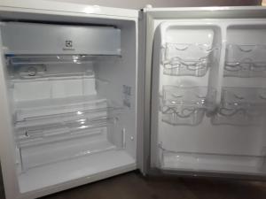 an empty refrigerator with its door open in a room at POUSADA DO BETO in Atins