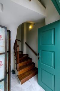 a green door in a hallway with a staircase at Kastello Hotel in Nafplio