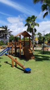 a playground with a slide in a park at Itacimirim - Quinta das Lagoas Reserva in Camaçari