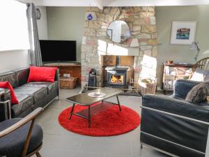 a living room with a couch and a fireplace at 15 Bogan in Eyemouth