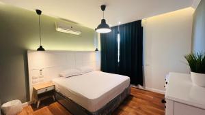 a bedroom with a white bed in a room at Sodic Westown Residence 2 in 6th Of October