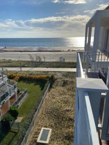a view of the beach from the balcony of a house at Meerblickvilla Großenbrode in Großenbrode