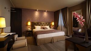a hotel room with a large bed and a desk at Arcadia Boutique Hotel in Venice +37 photos