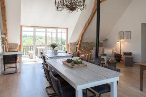 a large dining room with a table and chairs at B&B Fleur de Lys Bleue in Soudaine-Lavinadière +31 photos