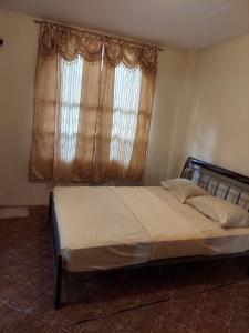 A bed or beds in a room at CASTLE VIEW VILLA