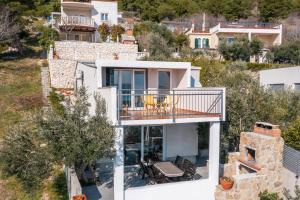 an aerial view of a house with a balcony at Mirabilis - Private Beach House in Lokva Rogoznica