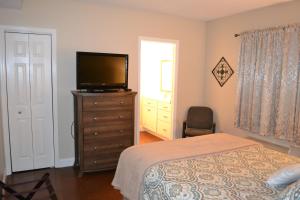 a bedroom with a bed and a television on a dresser at River Place Condos #504 2BD in Pigeon Forge +23 photos