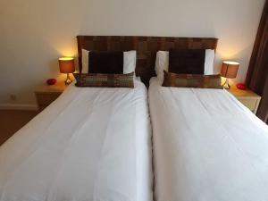 two beds sitting next to each other in a bedroom at Portreeves in Arundel