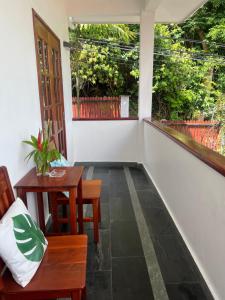 a balcony with a table and chairs and a window at Hilltop Boutique Hotel in Victoria