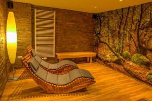 a couch in a room with a wall with a mural at Moselromantik Hotel Am Panoramabogen in Cochem
