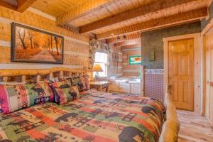 a bedroom with a large bed in a cabin at #152 Moonshadow in Townsend