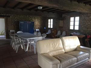 a living room with a couch and a table and chairs at La Sabatière in Bergerac