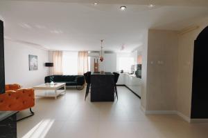 a white living room with a kitchen and a living room at Bear's Apartment Alba Iulia in Alba Iulia