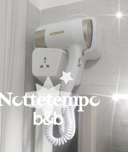 a white toilet with a star on the side of it at B&B Nottetempo in Paupisi