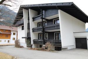 an apartment building with a black and white facade at FABIAN - Ski und Thermen Appartement in Bach