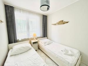 Posteľ alebo postele v izbe v ubytovaní Neptun by Baltic Home