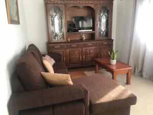 a living room with a couch and a tv at Casinha da Vila in Arcos de Valdevez