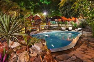 a large swimming pool in a yard with plants at Chalet Suisse in Natal